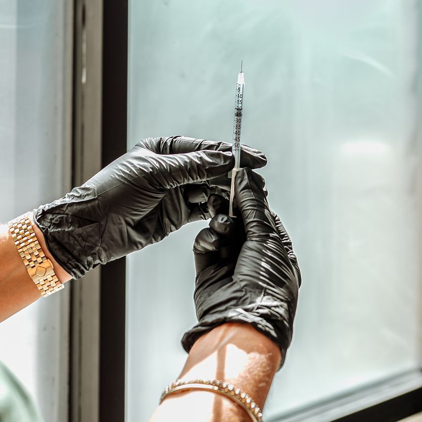 Gloved hands preparing a syringe at Contour & Sculpt Aesthetics